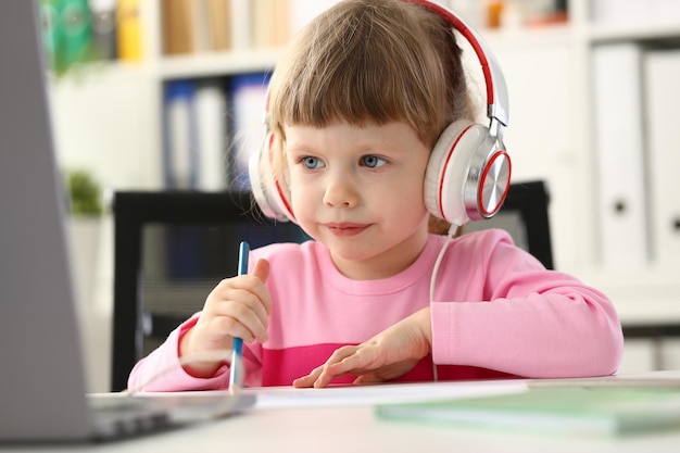 Little girl wearing headset fun pastime or online education