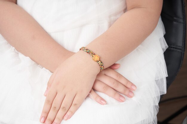 a little girl wearing a jewelry gold