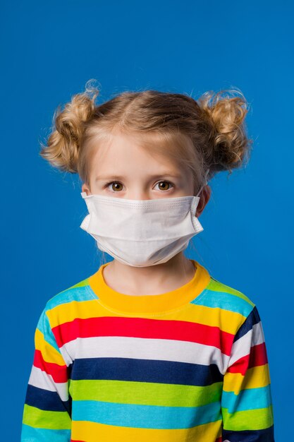 Little girl wearing a medical mask