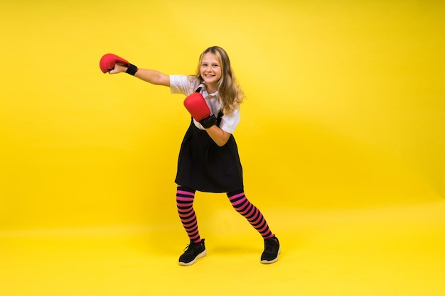 Little girl wearing red boxing gloves studio shot sport concept