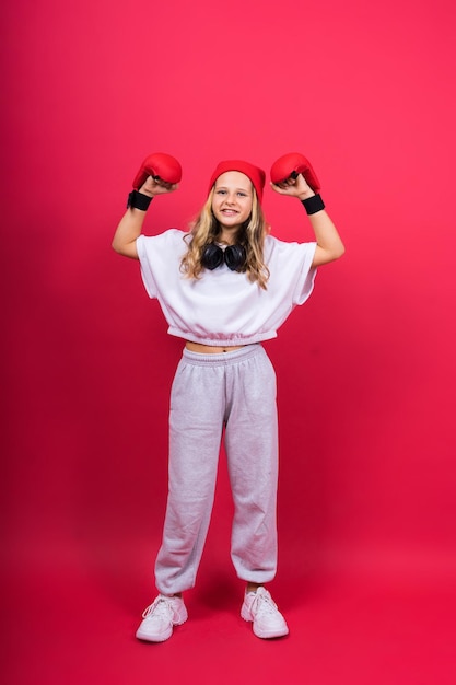 Little girl wearing red boxing gloves studio shot sport concept