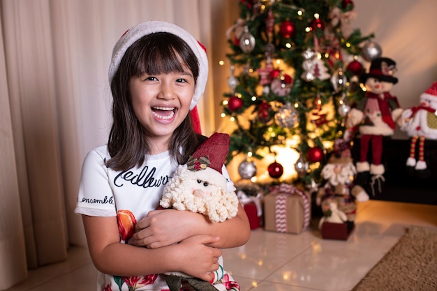 Little girl wearing Santa hat in Christmas decoration