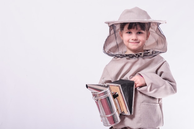 A little girl wears in bee suit in studio white background.