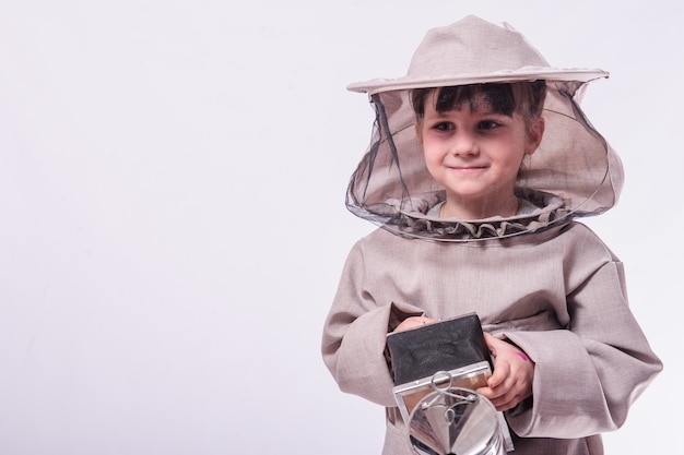 A little girl wears in bee suit in studio white background.