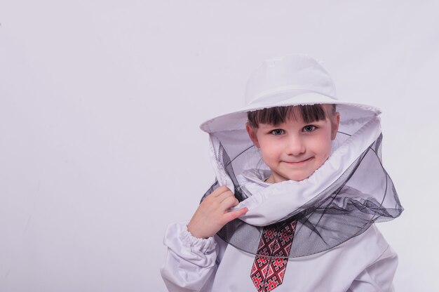 A little girl wears in bee suit in studio white background.