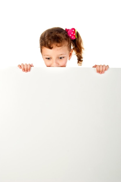 Little girl behind a white board