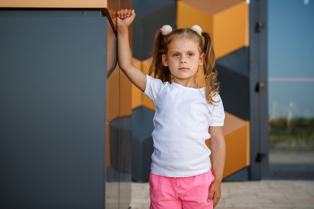 Little girl in white t-shirt. space for your logo or design. Mockup for print