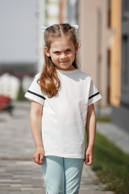 Little girl in white tshirt space for your logo or design Mockup for print