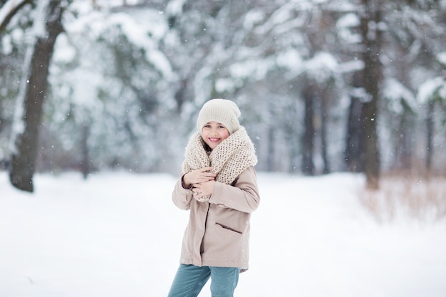 Little girl  in winter forest snow