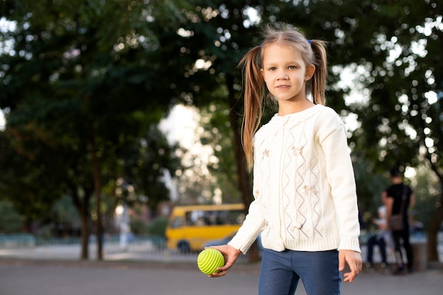 Little girl with ball in hand