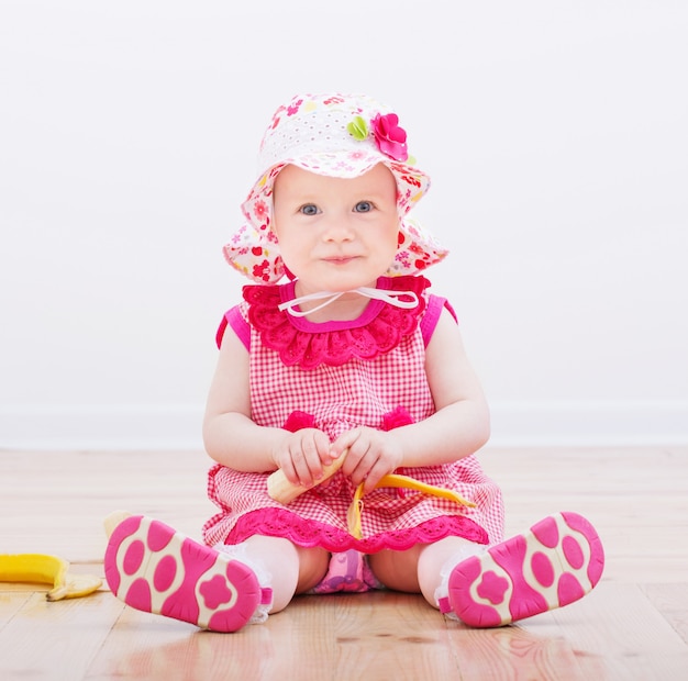 Little girl with banana indoor