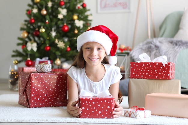 Little girl with christmas gifts in christmas interior