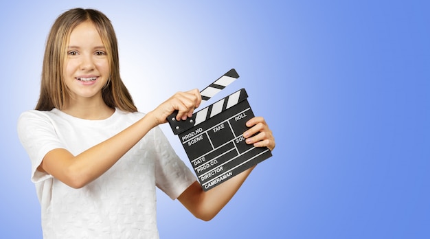 Little girl with a clapper board isolated