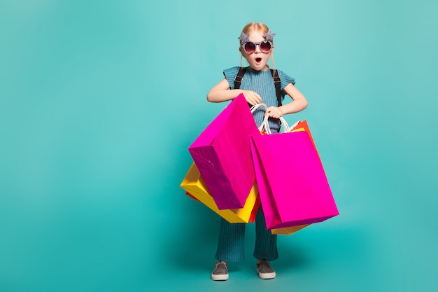 A little girl with colorful bags