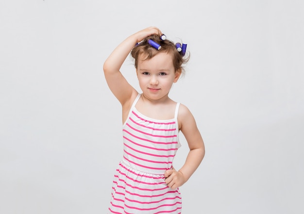 Little girl with curlers on her head