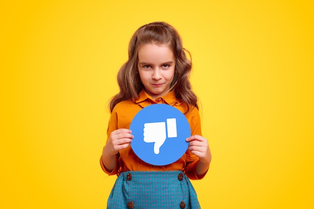 Little girl with dislike social networks sign