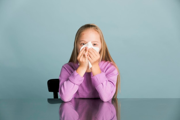 Little girl with Down Syndrome sneezing