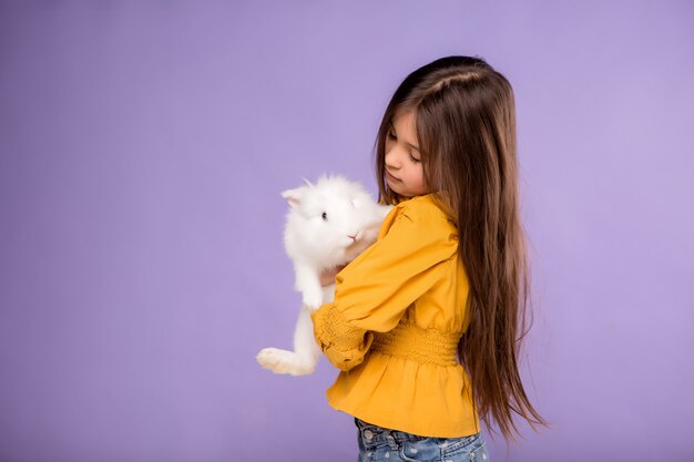 little girl with Easter Bunny on purple background