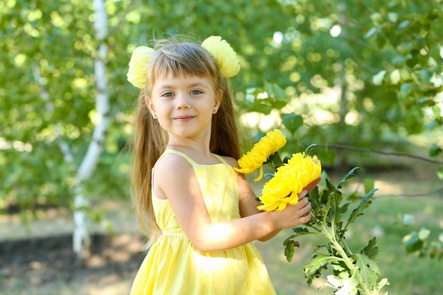 Little girl with flowers outside