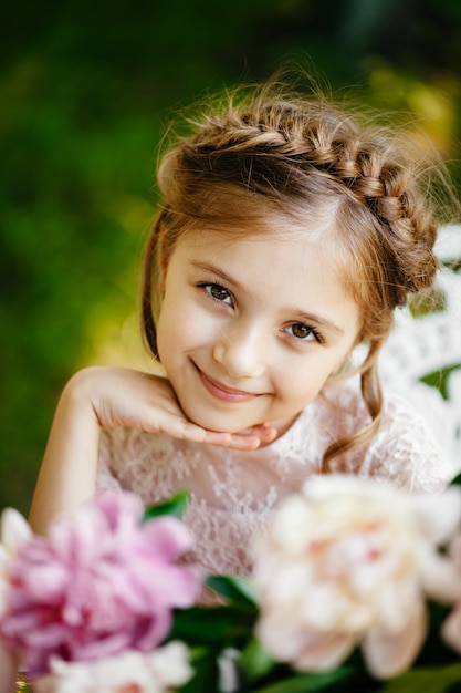 Little girl with flowers in the park