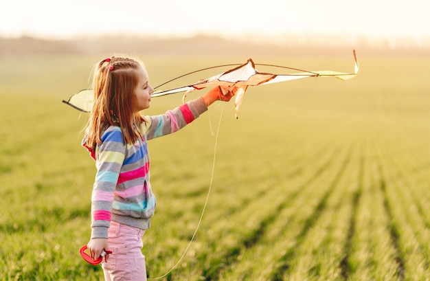 Little girl with flying kite