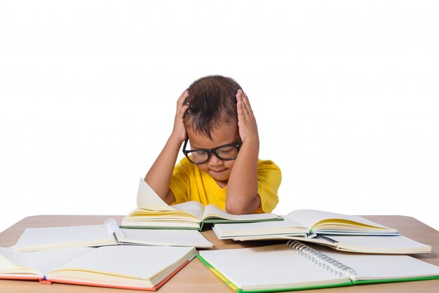 Little girl with glasses thought and many book on the table. back to school concept, isolated on white background