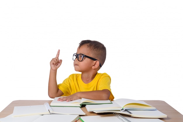 Little girl with glasses thought and many book on the table. 