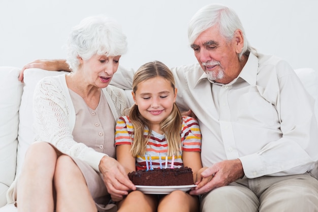 Little girl with grandparents celebrating birthday