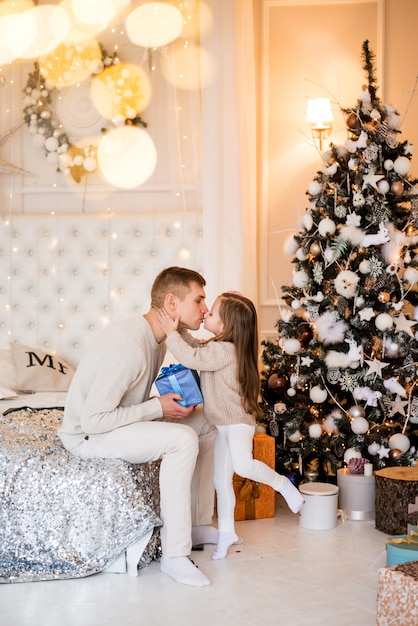 Little girl with her dad. Give gifts for the new year