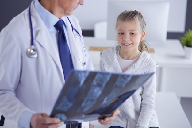 Little girl with her mother at a doctor on consultation