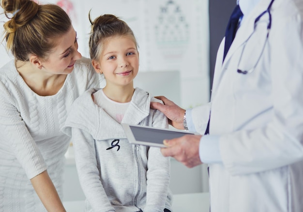 Little girl with her mother at a doctor on consultation