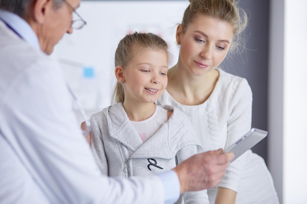 Little girl with her mother at a doctor on consultation