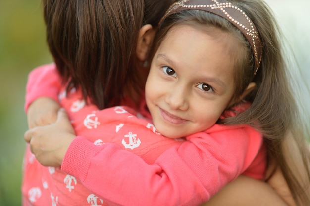 Little girl with her mother on a walk outdoors