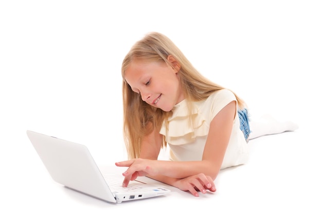 Little girl with laptop on white background