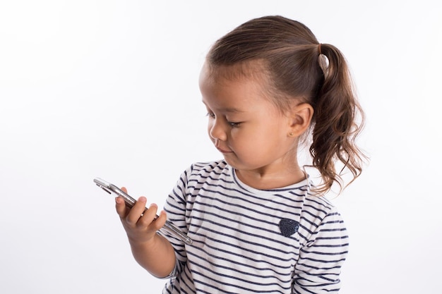 Photo little girl with mobile phone studio portrait mock up expressions going back to school with mask