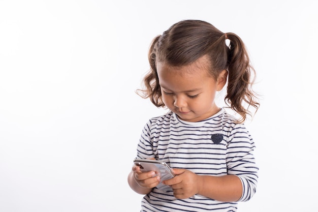 Photo little girl with mobile phone studio portrait mock up expressions going back to school with mask