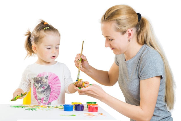 Маленькая девочка с мамой дурачится и играет с цветными красками