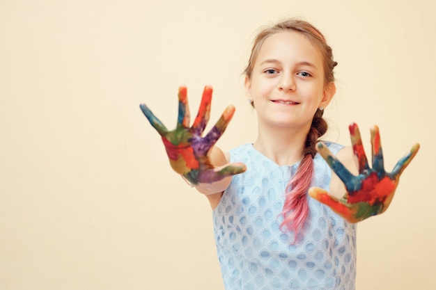 Little girl with palms in paints