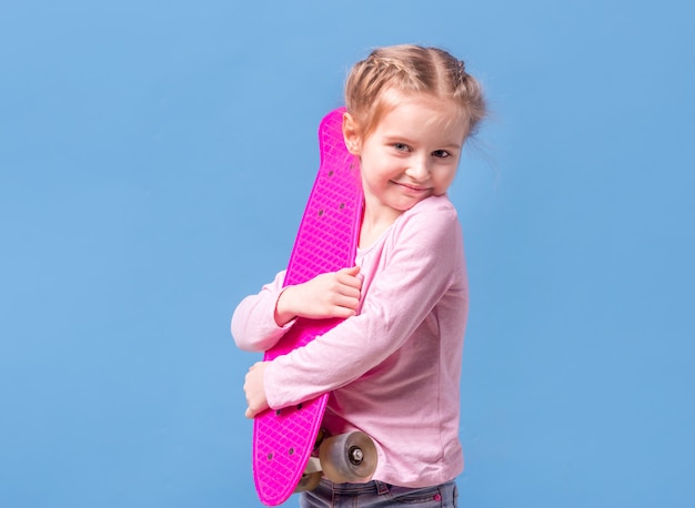 Little girl with pink skateboard