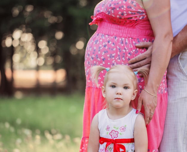 Little girl with pregnant women outdoor