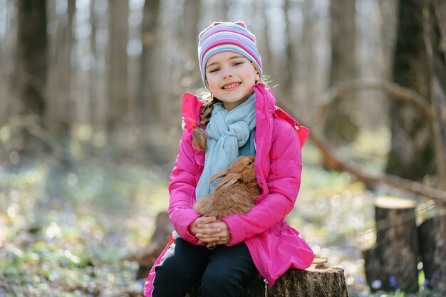 Little girl with a rabbit