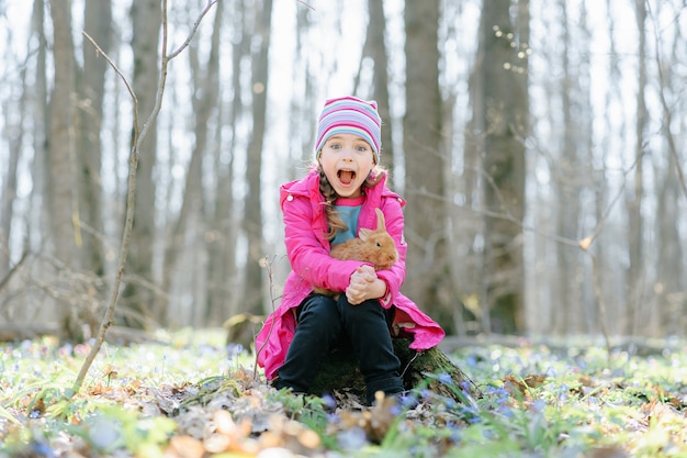 Little girl with a rabbit