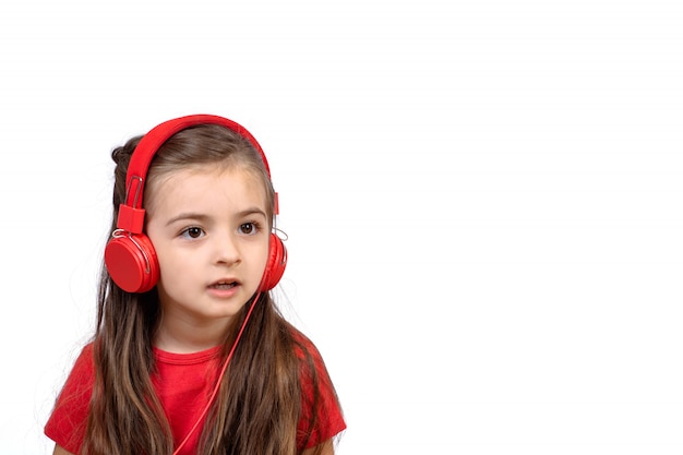 Little girl with red headphones.