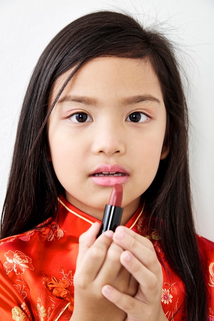 Little girl With red lipstick