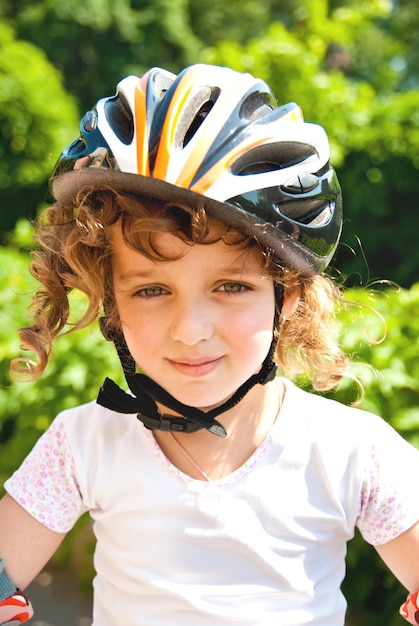 Little girl with rollers outdoors