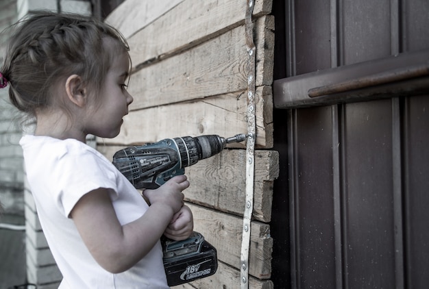 Little girl with screwdriver in hands