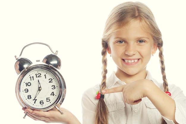 Photo little girl with a silvered alarm