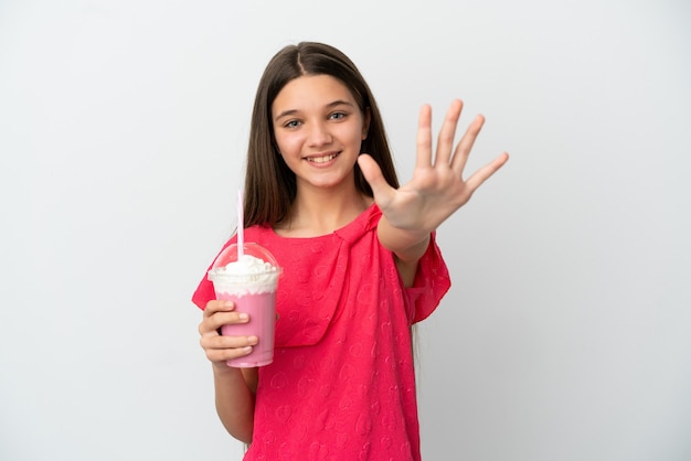 Little girl with strawberry milkshake over isolated white background counting five with fingers