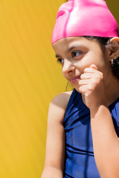 Little girl with a swimsuit is receiving the sun