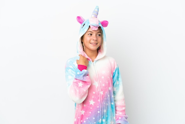 Little girl with unicorn pajamas isolated on white background thinking an idea